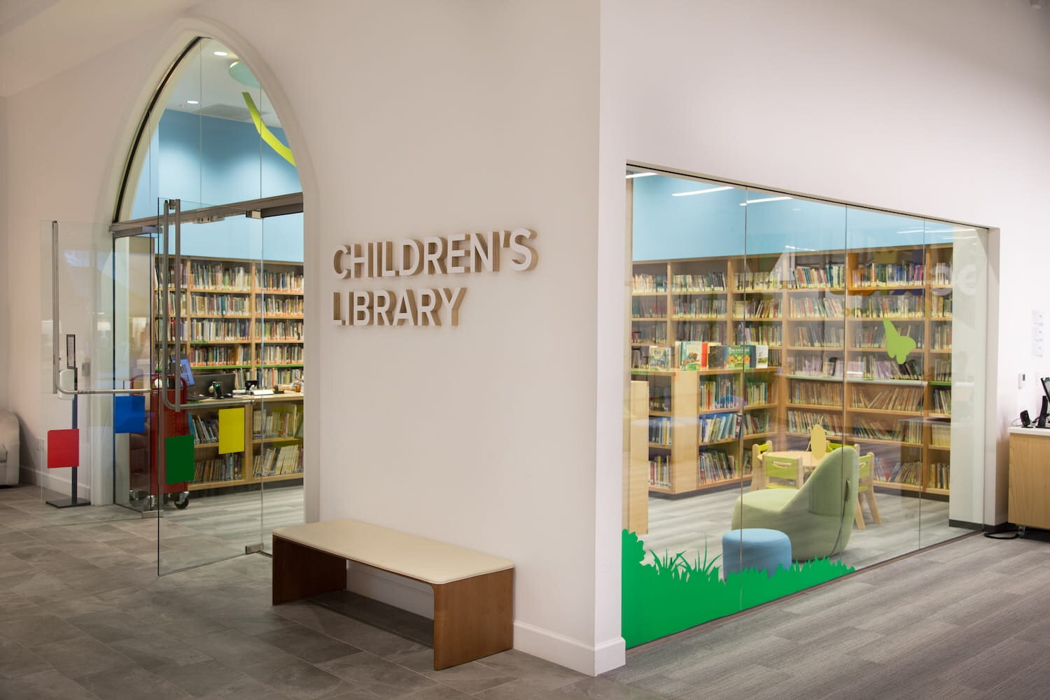 Children’s library at Park Cities Presbyterian Church with bookshelves, reading chairs, and glass entry doors.